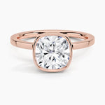 alt="An Cushion cut Moissanite engagement ring with a bezel setting, displayed on a gold band, against a white background.Moissanite engagement ring cape town south africa grand diamonds ralph jacobs jeulia "