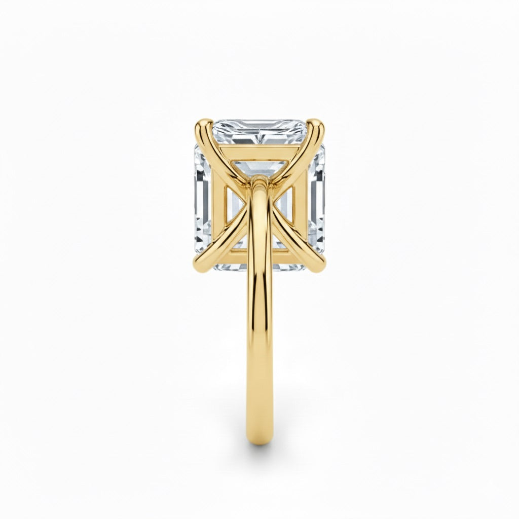 Asher  cut Moissanite lab grown diamond engagement ring round shank with a four claw setting, on a gold band, against a white background.Moissanite engagement ring cape town south africa grand diamonds ralph jacobs jeulia