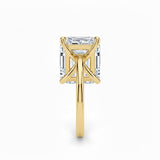 Asher  cut Moissanite lab grown diamond engagement ring round shank with a four claw setting, on a gold band, against a white background.Moissanite engagement ring cape town south africa grand diamonds ralph jacobs jeulia