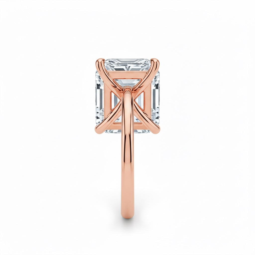 Asher  cut Moissanite lab grown diamond engagement ring round shank with a four claw setting, on a gold band, against a white background.Moissanite engagement ring cape town south africa grand diamonds ralph jacobs jeulia