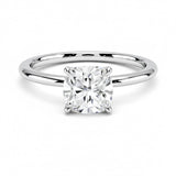 Cushion cut Moissanite lab grown diamond engagement ring round shank with a four claw setting, on a gold band, against a white background.Moissanite engagement ring cape town south africa grand diamonds ralph jacobs jeulia