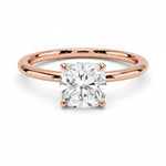 Cushion cut Moissanite lab grown diamond engagement ring round shank with a four claw setting, on a gold band, against a white background.Moissanite engagement ring cape town south africa grand diamonds ralph jacobs jeulia