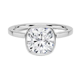 alt="An Cushion cut Moissanite engagement ring with a bezel setting, displayed on a gold band, against a white background.Moissanite engagement ring cape town south africa grand diamonds ralph jacobs jeulia "