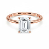 Emerald  cut Moissanite lab grown diamond engagement ring round shank with a four claw setting, on a gold band, against a white background.Moissanite engagement ring cape town south africa grand diamonds ralph jacobs jeulia