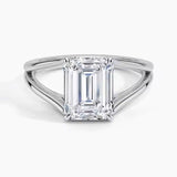 Emerald cut Moissanite lab grown diamond engagement ring round shank with a four claw setting, on a gold band, against a white background.Moissanite engagement ring cape town south africa grand diamonds ralph jacobs jeulia