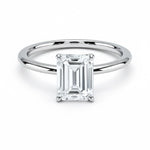 Emerald  cut Moissanite lab grown diamond engagement ring round shank with a four claw setting, on a gold band, against a white background.Moissanite engagement ring cape town south africa grand diamonds ralph jacobs jeulia