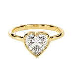 Heart shae Moissanite lab grown diamond engagement ring round shank with a bezel setting, on a gold band, against a white background.Moissanite engagement ring cape town south africa grand diamonds ralph jacobs jeulia