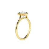 Heart shape Moissanite lab grown diamond engagement ring round shank with a bezel setting, on a gold band, against a white background.Moissanite engagement ring cape town south africa grand diamonds ralph jacobs jeulia