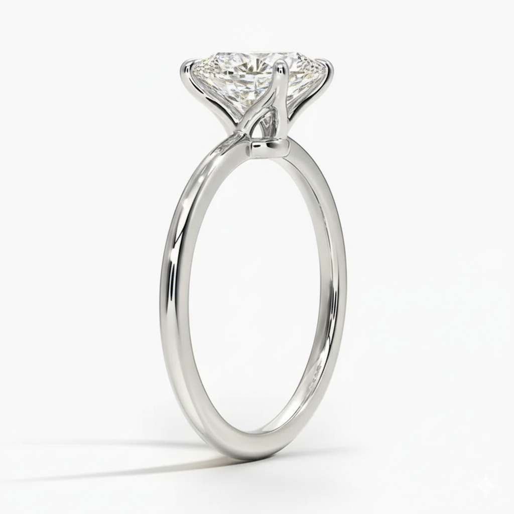 Oval cut Moissanite lab grown diamond engagement ring round shank with a four claw setting, on a gold band, against a white background.Moissanite engagement ring cape town south africa grand diamonds ralph jacobs jeuli