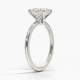 Oval cut Moissanite lab grown diamond engagement ring round shank with a four claw setting, on a gold band, against a white background.Moissanite engagement ring cape town south africa grand diamonds ralph jacobs jeuli