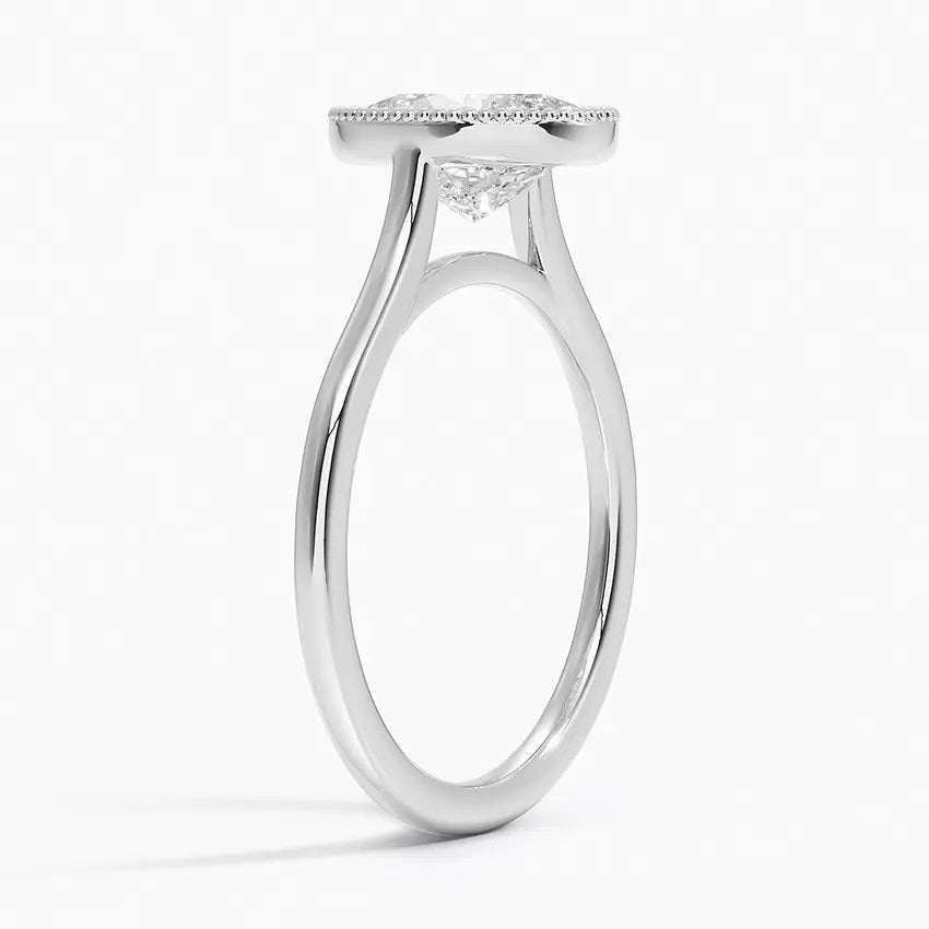 Oval shape Moissanite lab grown diamond engagement ring round shank with a bezel setting, on a gold band, against a white background.Moissanite engagement ring cape town south africa grand diamonds ralph jacobs jeulia