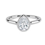 Pear shape Moissanite lab grown diamond engagement ring round shank with a bezel setting, on a gold band, against a white background.Moissanite engagement ring cape town south africa grand diamonds ralph jacobs jeulia