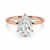 Pear cut Moissanite lab grown diamond engagement ring round shank with a six claw setting, on a gold band, against a white background.Moissanite engagement ring cape town south africa grand diamonds ralph jacobs jeuli