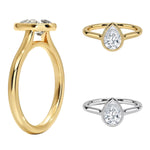 Pear shape Moissanite lab grown diamond engagement ring round shank with a bezel setting, on a gold band, against a white background.Moissanite engagement ring cape town south africa grand diamonds ralph jacobs jeulia