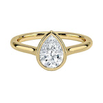 Pear shape Moissanite lab grown diamond engagement ring round shank with a bezel setting, on a gold band, against a white background.Moissanite engagement ring cape town south africa grand diamonds ralph jacobs jeulia