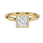 Princess cut Moissanite lab grown diamond engagement ring round shank with a bezel setting, on a gold band, against a white background.Moissanite engagement ring cape town south africa grand diamonds ralph jacobs jeulia