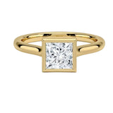 Princess cut Moissanite lab grown diamond engagement ring round shank with a bezel setting, on a gold band, against a white background.Moissanite engagement ring cape town south africa grand diamonds ralph jacobs jeulia