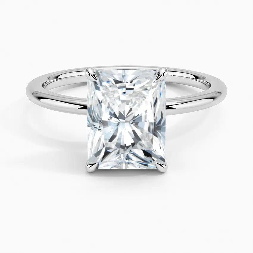 Radiant cut Moissanite lab grown diamond engagement ring round shank with a four claw setting, on a gold band, against a white background.Moissanite engagement ring cape town south africa grand diamonds ralph jacobs jeuli