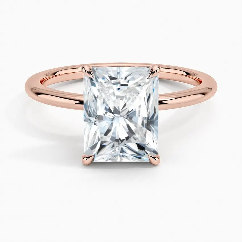 Radiant cut Moissanite lab grown diamond engagement ring round shank with a four claw setting, on a gold band, against a white background.Moissanite engagement ring cape town south africa grand diamonds ralph jacobs jeuli