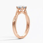 Round cut Twisted Shank Moissanite lab grown diamond engagement ring round shank with a four claw setting, on a gold band, against a white background.Moissanite engagement ring cape town south africa grand diamonds ralph jacobs jeuli