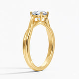 Round cut Twisted Shank Moissanite lab grown diamond engagement ring round shank with a four claw setting, on a gold band, against a white background.Moissanite engagement ring cape town south africa grand diamonds ralph jacobs jeuli