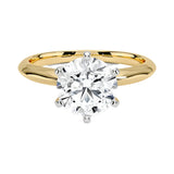Round cut Moissanite lab grown diamond engagement ring round shank with a six claw setting, on a gold band, against a white background.Moissanite engagement ring cape town south africa grand diamonds ralph jacobs jeuli