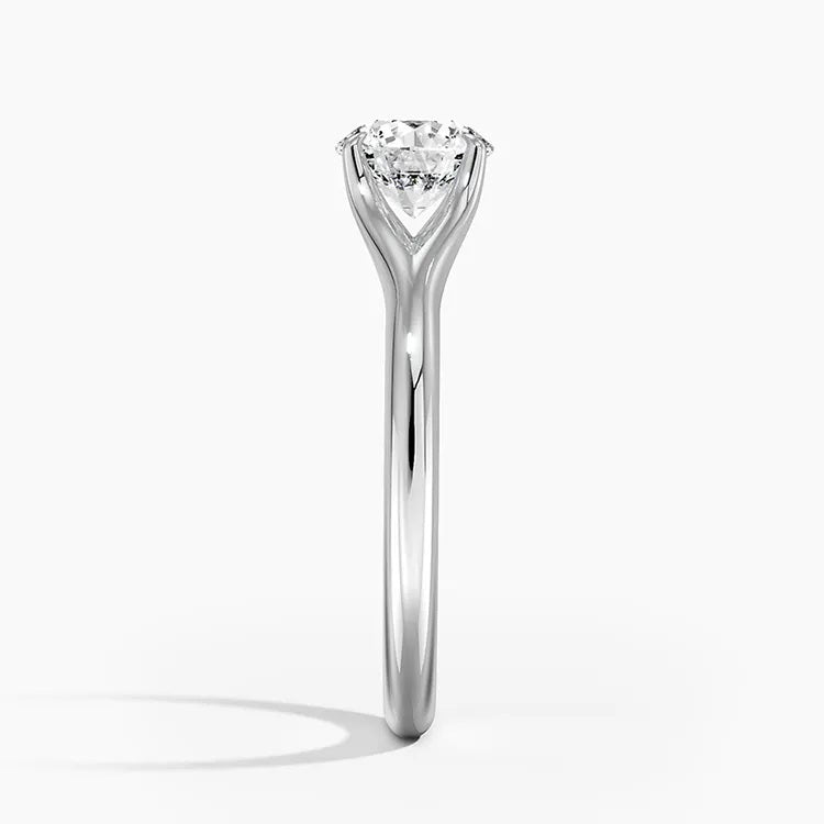 Round cut Split Shank Moissanite lab grown diamond engagement ring round shank with a six claw setting, on a gold band, against a white background.Moissanite engagement ring cape town south africa grand diamonds ralph jacobs jeuli