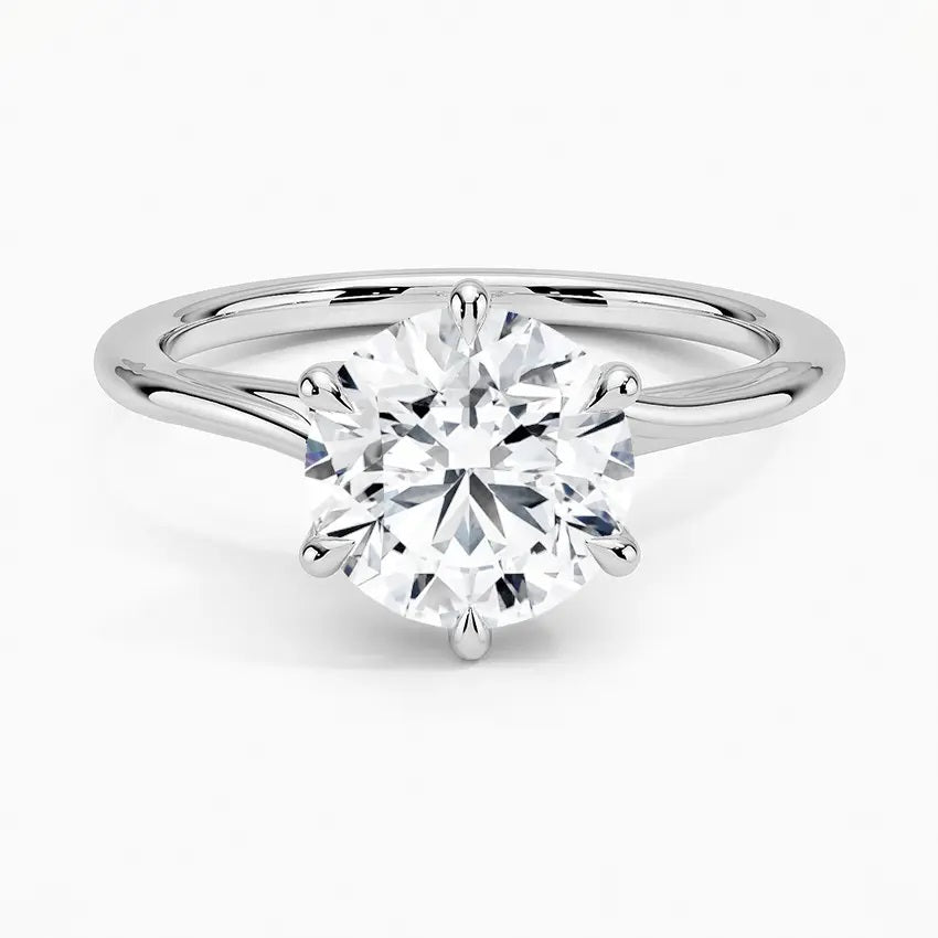 Round cut Moissanite lab grown diamond engagement ring round shank with a six claw setting, on a gold band, against a white background.Moissanite engagement ring cape town south africa grand diamonds ralph jacobs jeulia
