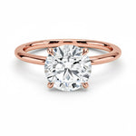 Engagement ring round cut Moissanite lab grown diamond engagement ring round shank with a four claw setting, on a gold band, against a white background.Moissanite engagement ring cape town south africa grand diamonds ralph jacobs jeulia