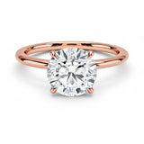 Engagement ring round cut Moissanite lab grown diamond engagement ring round shank with a four claw setting, on a gold band, against a white background.Moissanite engagement ring cape town south africa grand diamonds ralph jacobs jeulia