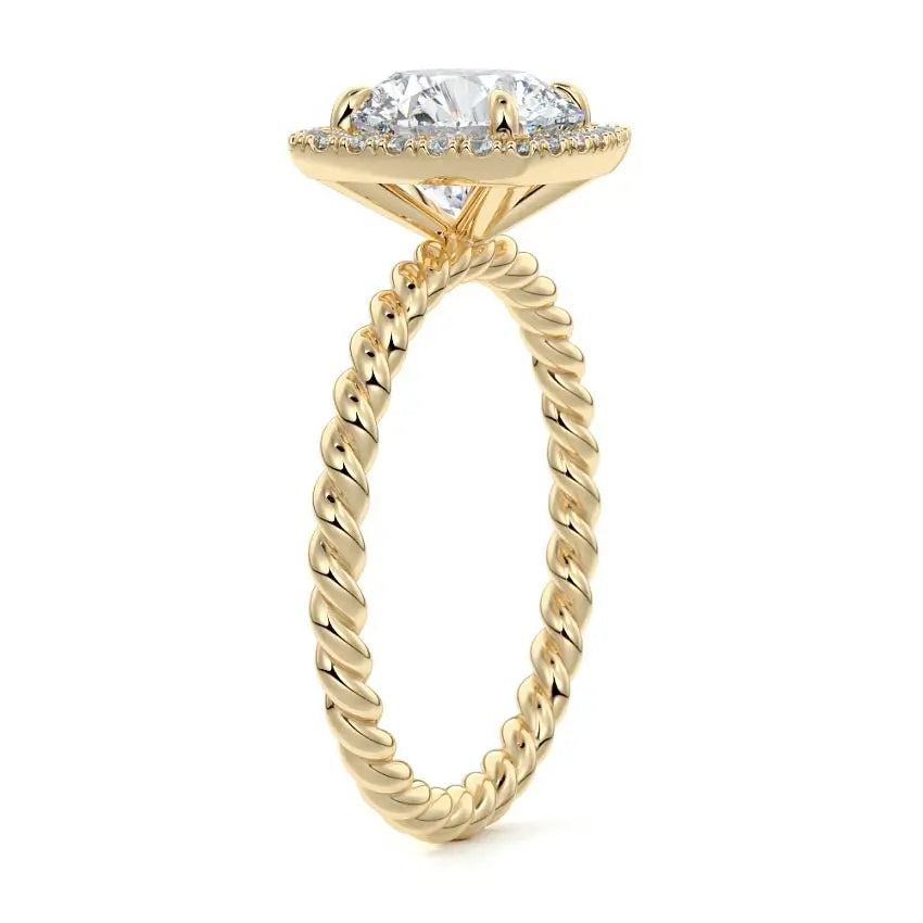 alt="Round-cut moissanite engagement ring with a halo and a twisted pavé band by ApolloGem"