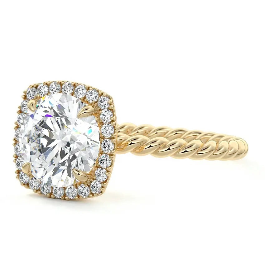 alt="Round-cut moissanite engagement ring with a halo and a twisted pavé band by ApolloGem"