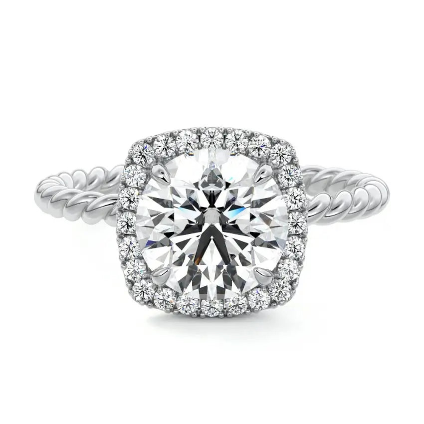 alt="Round-cut moissanite engagement ring with a halo and a twisted pavé band by ApolloGem"