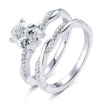 alt="Elegant oval cut engagement ring set with a twisted wedding band by ApolloGem"