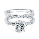 alt="Elegant oval cut engagement ring set with a twisted wedding band by ApolloGem"