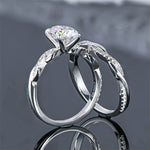 alt="Elegant oval cut engagement ring set with a twisted wedding band by ApolloGem"