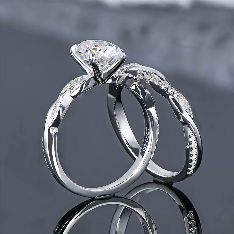alt="Elegant oval cut engagement ring set with a twisted wedding band by ApolloGem"