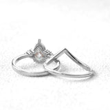 alt="Pear cut moissanite engagement ring cape town set with a matching half eternity V-shaped wedding band by ApolloGem"