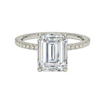 Diamond ring with emerald-cut center stone on a white background