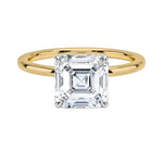 Asher  cut Moissanite lab grown diamond engagement ring round shank with a four claw setting, on a gold band, against a white background.Moissanite engagement ring cape town south africa grand diamonds ralph jacobs jeulia 