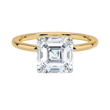 Asher  cut Moissanite lab grown diamond engagement ring round shank with a four claw setting, on a gold band, against a white background.Moissanite engagement ring cape town south africa grand diamonds ralph jacobs jeulia 