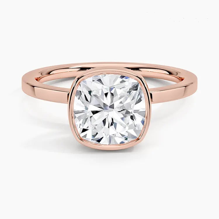 alt="An Cushion cut Moissanite engagement ring with a bezel setting, displayed on a gold band, against a white background.Moissanite engagement ring cape town south africa grand diamonds ralph jacobs jeulia "
