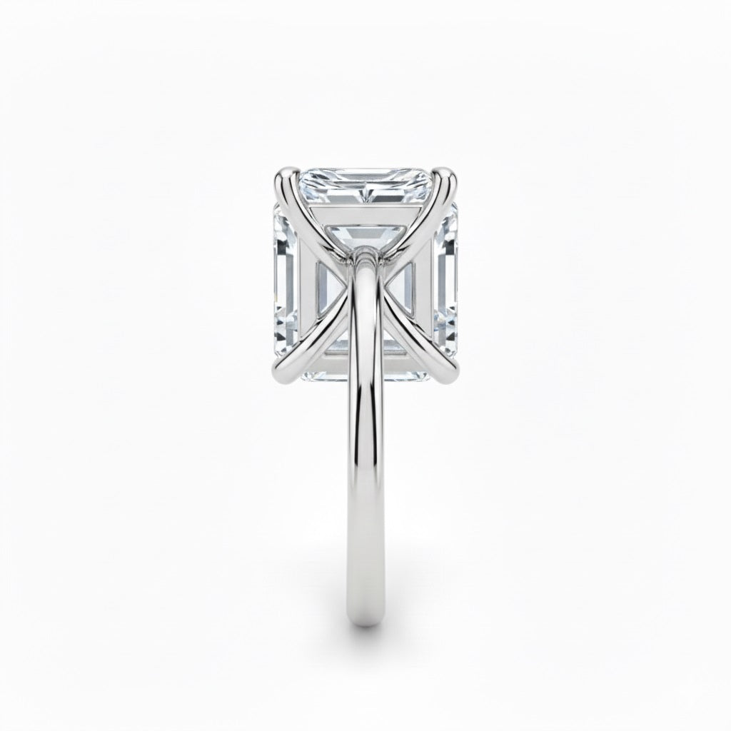 Asher  cut Moissanite lab grown diamond engagement ring round shank with a four claw setting, on a gold band, against a white background.Moissanite engagement ring cape town south africa grand diamonds ralph jacobs jeulia 