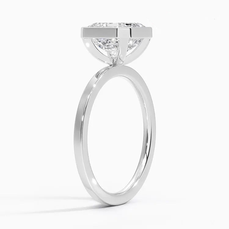 alt="An Asscher-cut Moissanite engagement ring with a bezel setting, gold band.Moissanite engagement ring cape town south africa grand diamonds ralph jacobs jeulia "