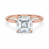 Asher  cut Moissanite lab grown diamond engagement ring round shank with a four claw setting, on a gold band, against a white background.Moissanite engagement ring cape town south africa grand diamonds ralph jacobs jeulia 