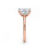 Asher  cut Moissanite lab grown diamond engagement ring round shank with a four claw setting, on a gold band, against a white background.Moissanite engagement ring cape town south africa grand diamonds ralph jacobs jeulia 