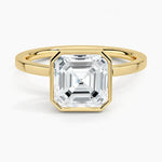 alt="An Asscher-cut Moissanite engagement ring with a bezel setting, displayed on a gold band, against a white background.Moissanite engagement ring cape town south africa grand diamonds ralph jacobs jeulia "
