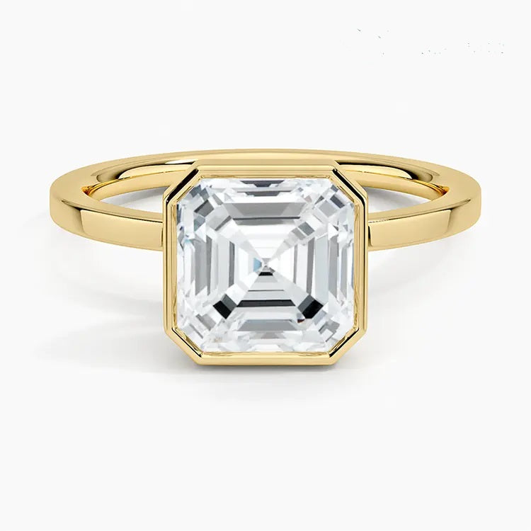 alt="An Asscher-cut Moissanite engagement ring with a bezel setting, displayed on a gold band, against a white background.Moissanite engagement ring cape town south africa grand diamonds ralph jacobs jeulia "