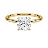 Cushion cut Moissanite lab grown diamond engagement ring round shank with a four claw setting, on a gold band, against a white background.Moissanite engagement ring cape town south africa grand diamonds ralph jacobs jeulia 