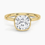 alt="An Cushion cut Moissanite engagement ring with a bezel setting, displayed on a gold band, against a white background.Moissanite engagement ring cape town south africa grand diamonds ralph jacobs jeulia "